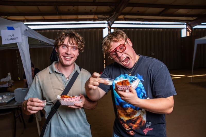 Festival-goers enjoying chicken wings at the Austin Chicken Wing Festival